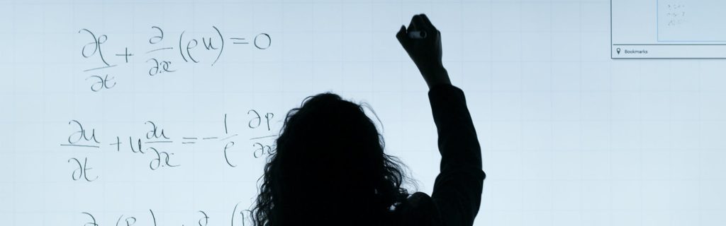 Woman Writing On A Whiteboard
